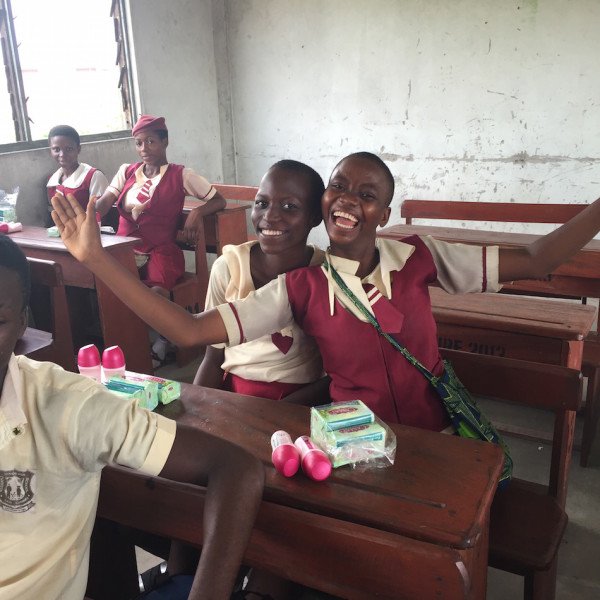Happy students in their classroom receiving the donated products from Unilever Nigeria